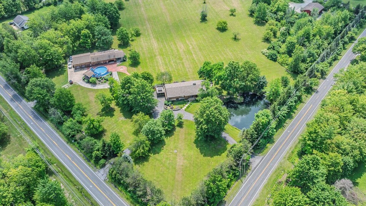 Painesville Cabin | Spacious 5-bedroom lodge on 35 acres with pool house, pool, 2 ponds, waterfall!