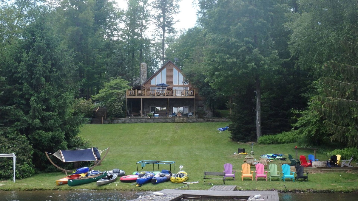 Treasure Lake House | Spacious Lakefront Log Home with large lakefront porch, firepit