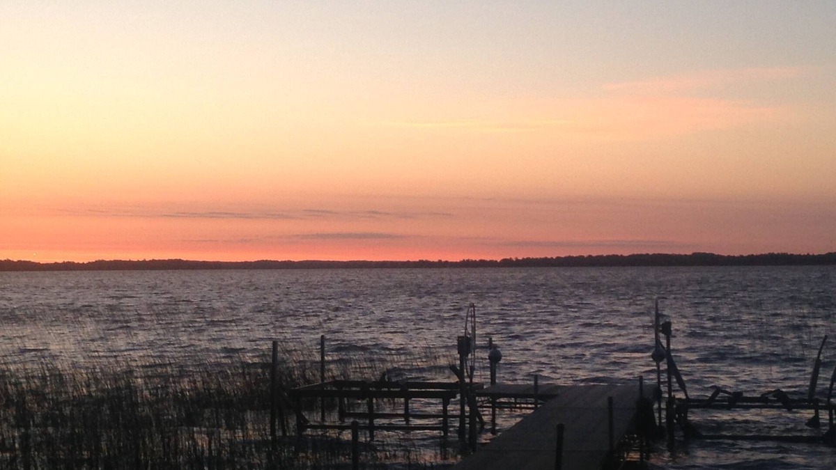 Dent House | Spectacular sunrise glistening off the lake from this quiet lakeside retreat