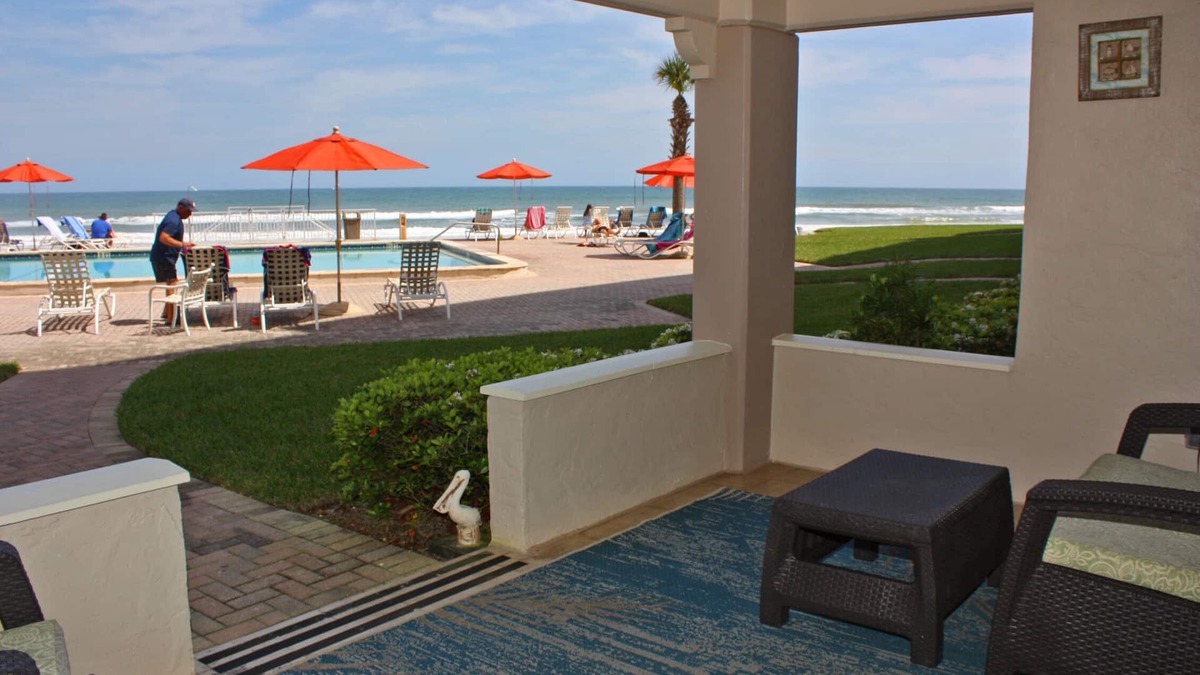New Smyrna Beach Condo | Steps to south pool deck, pool and ocean from this ground floor, three bedroom, three bath sleeps 8.