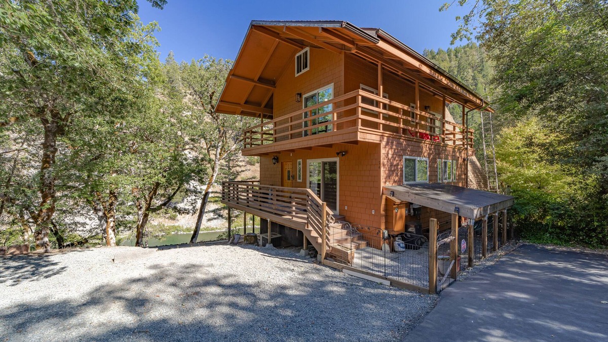 Salyer House | Stunning riverfront gem w/wraparound deck, beach access & game room