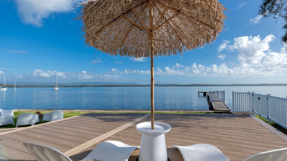 Bonnells Bay Apartment | The Boathouse- Unwind at this tranquil, absolute waterfront, luxury Boathouse nestled on the edge of