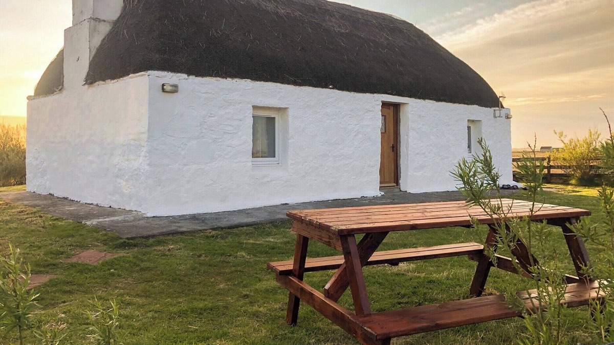 Benbecula Cottage | The cottage is so attractive with its traditional thatch and whitewashed walls.