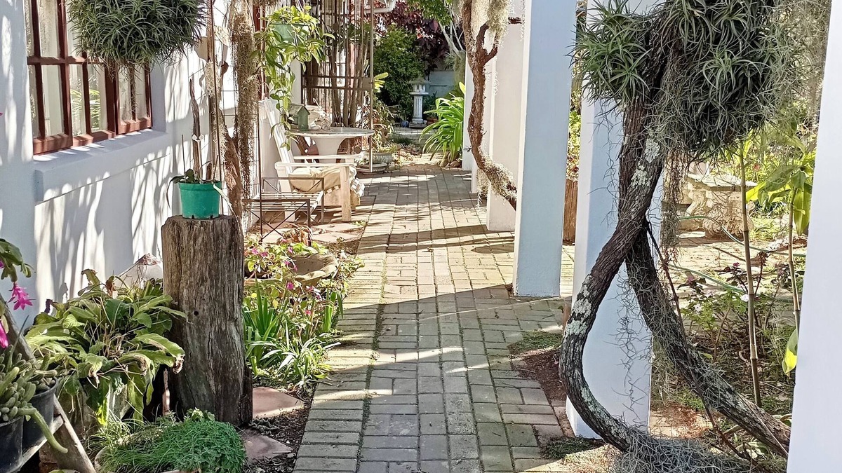 Mossel Bay House | This cozy home is nestled in a beautiful secret garden.