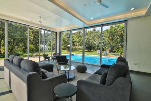 Khalapur Villa | Twilight Grove by StayVista - Pool- view villa with Manicured lawn, Contemporary interiors & Home theatre
