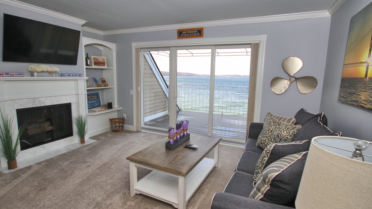 Boyne City Condo | Vaulted Ceilings + Prime Lake Charlevoix Views | Fireplace | Private Patio|