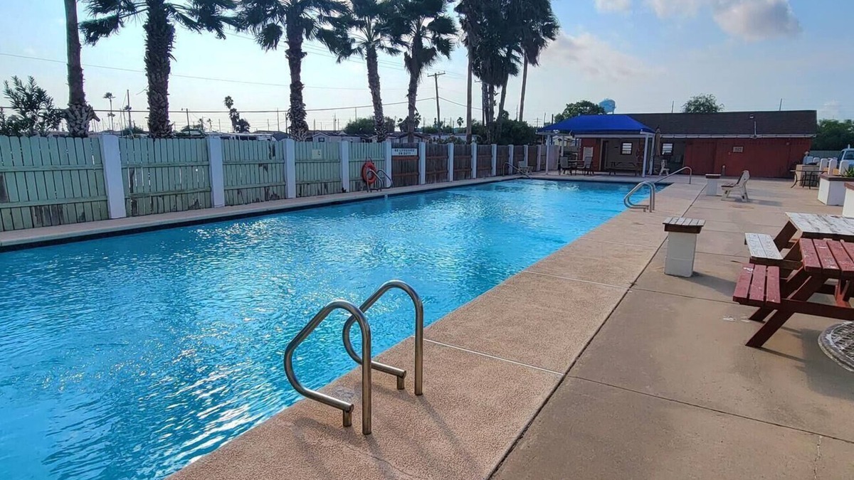 Port Isabel Condo | waterfront - boat slip - pool - bay sunset views