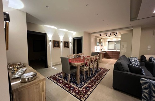 Sahab Apartment | 3 bed room apartment with modern kitchen indoor and out door seating area .