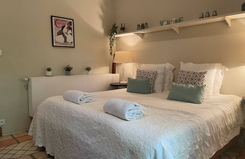 Villamblard Bed & Breakfast | A beautiful romantic bedroom with a mezzanine area, bathroom and private garden