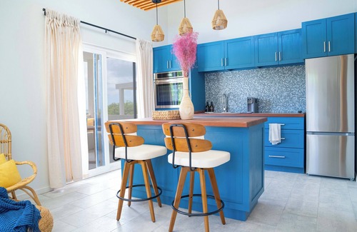 Osbourn Cottage | Affordable luxury, with runway views and tropical breeze.
