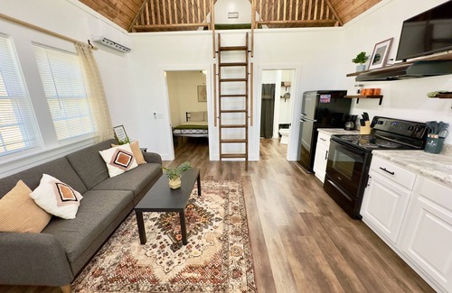 Albertville Cabin | Bass Luxury Tiny Cabin on Lake with Jump Houses