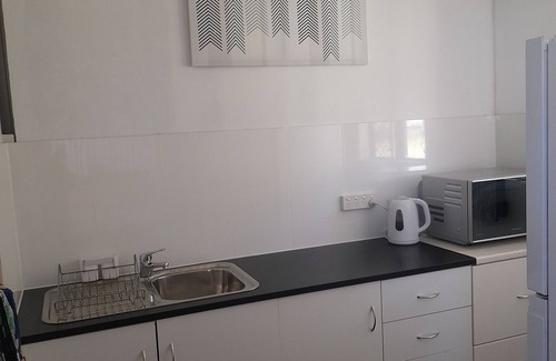 Coonarr Cabin | Bundaberg PETS A/C Small Rustic Cabin 1 bed kitchenette fridge bathroom BBQ deck