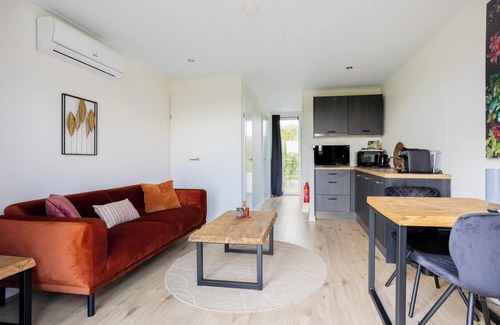 Gasselte House | Charming tiny house with a deck by the water. Relax, enjoy nature near ’t Nije Hemelriek and unwind – from sipping cappuccino in the sun to stargazing by the firepit.