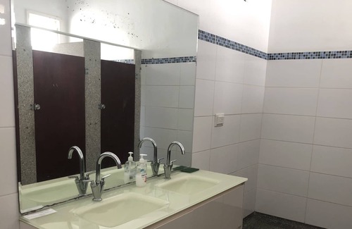 Proserpine Apartment | Clean tidy hotel room with a shared kitchen and shower area