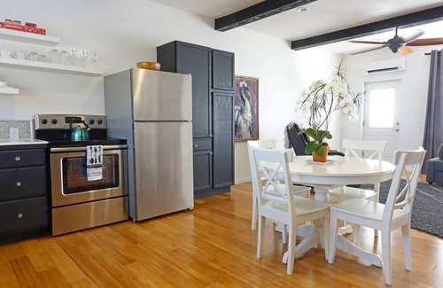 Talent Apartment | Cottage 1 offers a king-sized bed, dining area, full kitchen, hot tub.