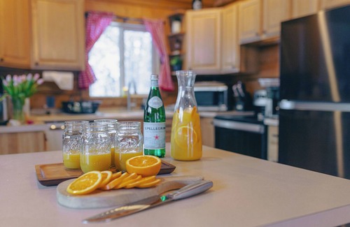 Saint Mary's Cabin | Cozy Log Cabin: hot tub under the stars, private deck, king bed, dog friendly!