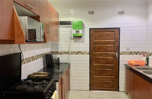Lusaka Cottage | Cozy, quiet and beautiful two bedroom gated cottage. Full kitchen & pool access.