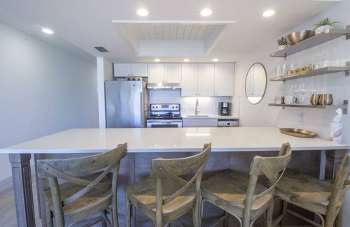Vanderbilt Beach Condo | Designer Condo! Walk to the Beach! Bay Views! Rooftop Pool! Fully Renovated!