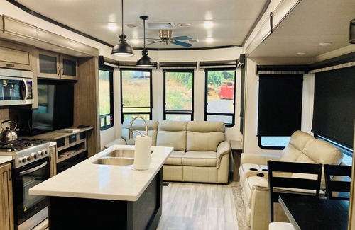 Ariel House | Glamping at Coyote Ridge! Camp out in style in a luxury cottage RV! W/firepit