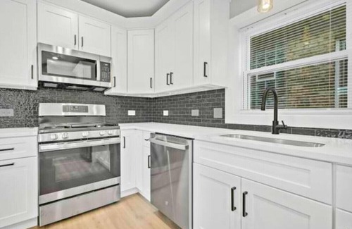 Chester Highlands House | House with garage, outdoor dining and basement bar
