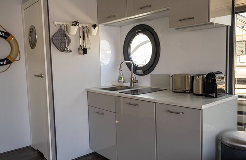 Flensburg Boat Rental | Houseboat Luv in Sonwik harbor with a view of Denmark