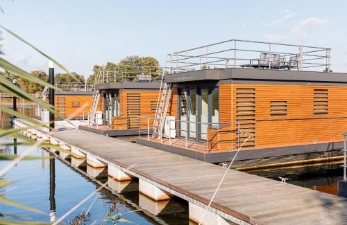 Leuken Boat Rental | Houseboat with edge of a holiday park