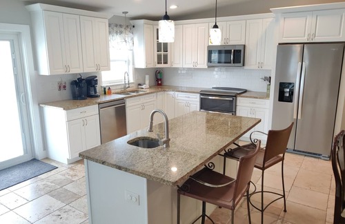 Butler Beach House | Island Escape - Water Views, Heated Pool, Boat Dock, Walk to Beach