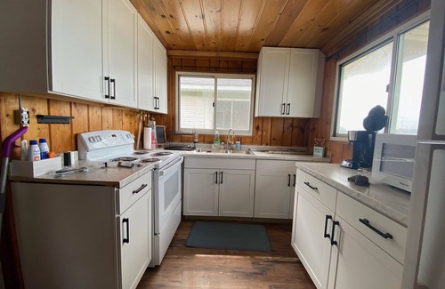 National City Cottage | Lake/beach front property with kayaks, pedal boat, & row boat, near Tawas Bay