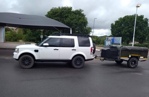 Hilton House | Land Rover Discovery, roof top tent and off road trailer with driver