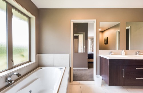 Rolleston House | Large master bedroom with en-suite and bath in our Private House