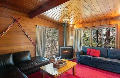 Sawmill Settlement Cabin | Lumi Talo - Retro quintessential two-story cedar lodge