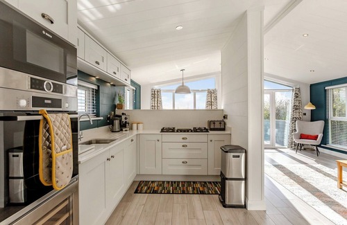 Middlezoy Ski Chalet | Luxurious lodge with vaulted ceilings and a welcoming feature fireplace.