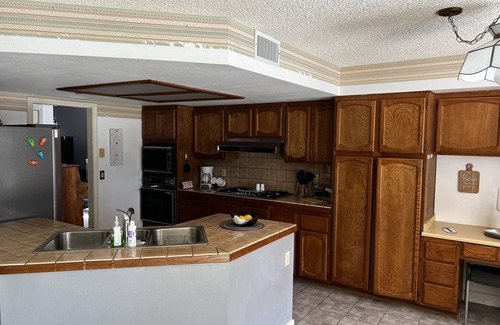 Paradise House | Master Bedroom and bath in a Vegas home with pool & 7 minutes to the stripn