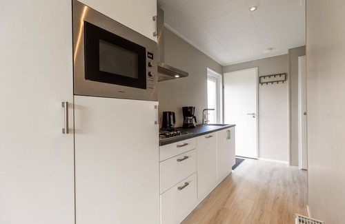 Lathum House | Modern holiday home with a view of a tranquil pond