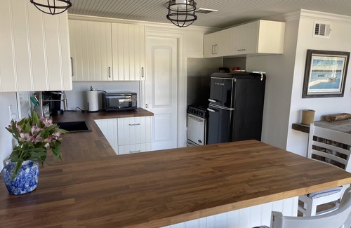 Northport Cottage | Northport quaint restored Boathouse with sunset views!