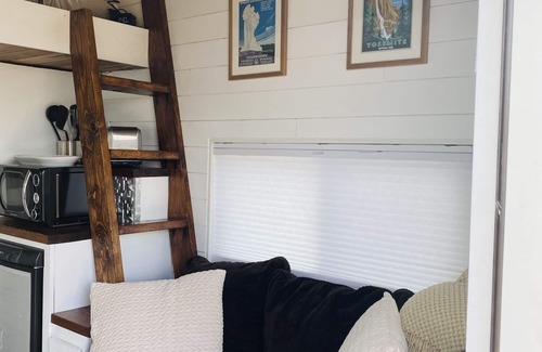 Meeker House | Our tiniest Tiny Home packs a punch! It contains a Queen bed in a loft accessed by a ladder. Sleeps: 2
