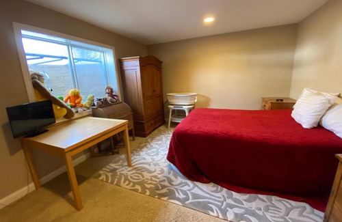 Maxwell House | Private basement bedroom with private bathroom, kitchen, and living room with large screen television