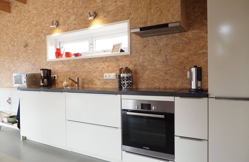 Gasselte House | Relax on the lovely lounge sofas with panoramic views of the nature garden? Or a week of quiet (tele)work, while walking straight into the woods for a lunch walk during your break?