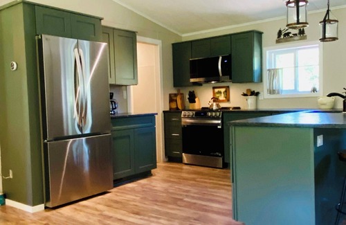 Trail House | Riverfront Gem with Big Deck, Fishing & Adventure. Comfy beds, upgraded beauty