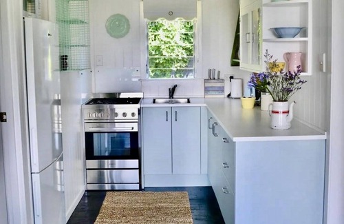 Stanmore Bay Cottage | Rosie's cottage in Stanmore Bay , a short walk to beach with a great seaview.