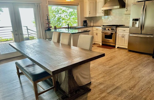 Lafayette County House | Secluded getaway with lakefront views. Spacious covered deck and dock access.