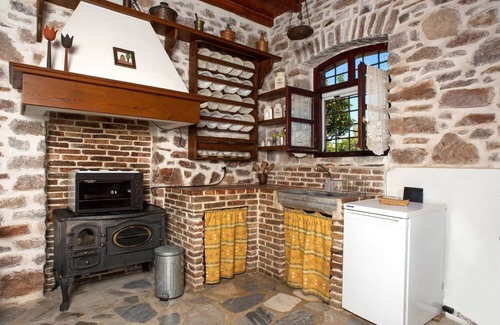 Syros Cottage | Stone-built studio under two Eucalyptus trees.