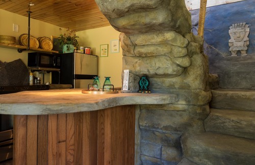 Wildwood Cottage | The Cavern on The Green. A unique hand-carved home. Quiet, great views