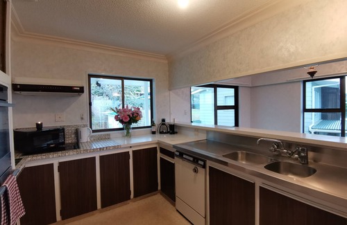 Snells Beach House | The Peach on the Beach! Pick up the paddle board and go!
