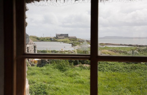 Outer Hebrides Cottage | Traditional stone and thatch cottage on the waters edge with beautiful sea views