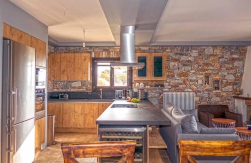 Megas Gialos Villa | Villa Camellia is a beautiful stone house overlooking the sea.