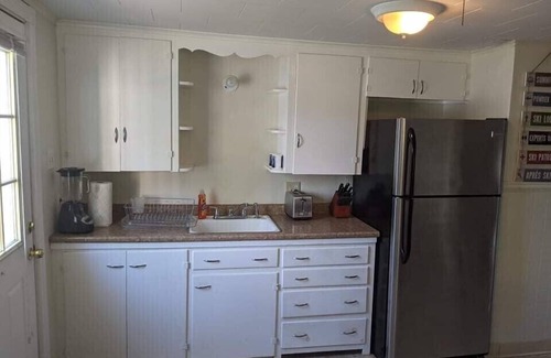 Winnisquam House | Winnisquam Lakeside Funky Ski Chalet w-Sandy Beach & Boat Docks