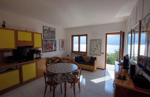 Assenza Apartment | Wonderful balcony on the lake with beautiful pool and garden among palm and olive trees