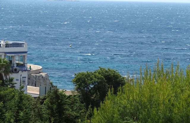 A balcony over the sea. A room in town