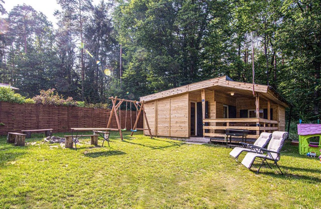 A modern wooden cottage near the lake awaits you.